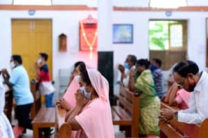 Catholic devotees wear face mask attend the Holy Mass at the Saint Joseph's Church on the first day after the reopening of religious services after the government eased restrictions imposed as a preventive measure against the COVID-19 coronavirus, in Hyderabad on June 8, 2020. (Photo by NOAH SEELAM / AFP) (Photo by NOAH SEELAM/AFP via Getty Images)